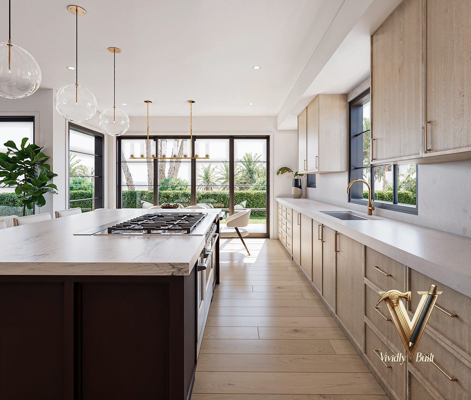 Galley view down the marble island and range with rift-oak cabinetry and brass hardware, opening to the terrace — Pacific Palisades fire rebuild
