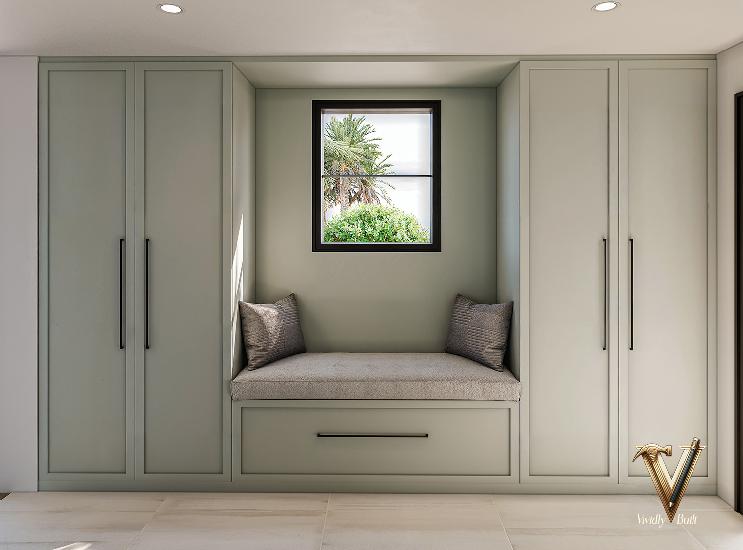 Mudroom with sage floor-to-ceiling cabinetry and a cushioned window seat under a garden window — Pacific Palisades fire rebuild