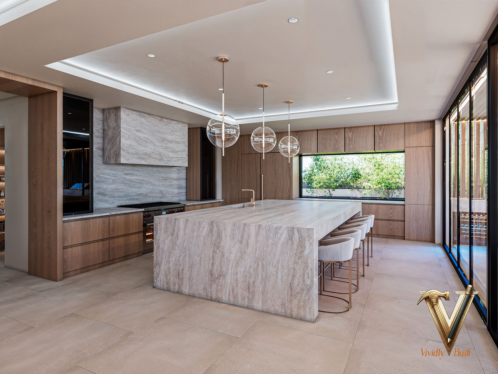 Travertine chef's kitchen with a full-slab island, integrated appliances and a glass-front pantry - Palos Verdes estate by Vividly Built