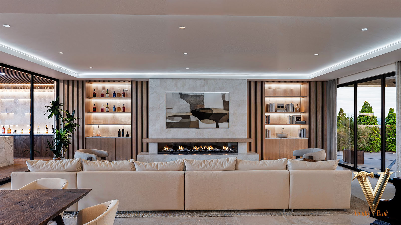 Glass-walled great room opening to the ocean-view terrace, with a linear fireplace and warm oak ceiling - Palos Verdes estate by Vividly Built